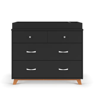 The Child Craft Soho 3-Drawer Dresser in Ebony features a modern black finish, silver handles, flat top, and angled wooden legs, shown against a white background.