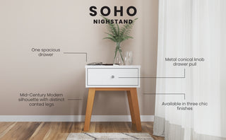 The Child Craft Soho Nightstand in White/Natural features wood legs, a spacious white drawer with a metal conical knob, and comes in three finishes. Shown against a neutral wall, it doubles as nursery furniture, with a plant and glass on top.