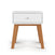 The Child Craft Soho Nightstand in White/Natural features a modern mid-century design with a single drawer and natural wooden legs, displayed against a plain white background.