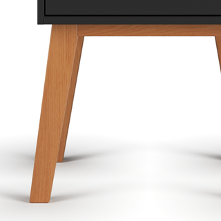 Close-up of the wooden legs and lower portion of the Soho Nightstand in Ebony by Child Craft, shown against a white background.