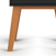 Close-up of the wooden legs and lower portion of the Soho Nightstand in Ebony by Child Craft, shown against a white background.