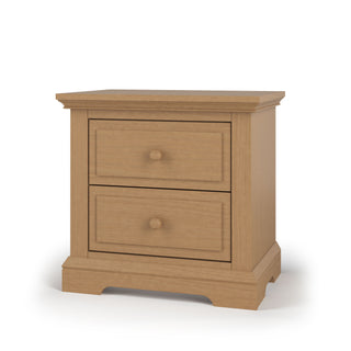 The Child Craft Jordyn Nightstand, Ready-to-Assemble in Biscotti finish, features crown molding accents and two drawers with round knobs, shown against a white background.