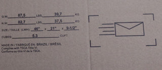 Close-up of a cardboard box for the Child Craft Ocean Grove Double Dresser, White/Gray. Shows shipping info in English, French, and Portuguese, plus package dimensions, weight, volume, an envelope graphic, and "Made in Brazil.