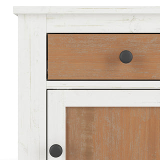 Close-up of the Ocean Grove Nightstand by Child Craft, featuring a white and brown finish, single drawer and door with round black knobs, and rustic nautical farmhouse style—perfect distressed charm for any nursery.