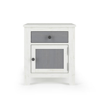 The Child Craft Ocean Grove Nightstand in white/gray features four legs, a dark gray drawer, and a matching cabinet door with round black knobs, all shown against a plain white background.