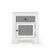 The Child Craft Ocean Grove Nightstand in white/gray features four legs, a dark gray drawer, and a matching cabinet door with round black knobs, all shown against a plain white background.