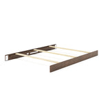 A partially assembled Child Craft F06401 full-size bed shows a dark brown headboard and footboard, with cocoa bean-finished bed rails and light pine support slats running across the width.