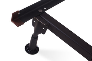 Close-up of a Hollywood Metal Bed Frame corner by Child Craft, featuring a support leg and brown plastic end cap, shown against a white background.