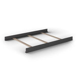 The Child Craft F06454 Full-Size Bed Rails in Cool Gray are shown on a white background, designed to pair seamlessly with a minimalist black and wood bed frame featuring solid black panels and three light wood slats across the middle.