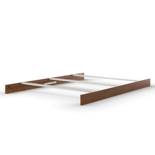 The Child Craft F06474 Full-Size Bed Rails in Coach Cherry feature a brown wooden finish with white support beams and bed rails, displayed without a mattress or headboard on a white background.