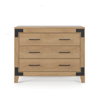 The Lucas Dresser by Child Craft in nutmeg features three drawers, black metal corner brackets and handles, and stands on four short legs, all displayed against a white background.