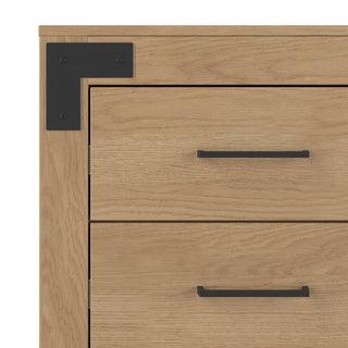 Close-up of the Lucas Dresser by Child Craft in Nutmeg finish, showing two drawers with black horizontal handles and a black metal corner bracket attached to the top left corner.