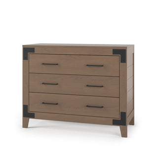 The Lucas Dresser by Child Craft in Dusty Heather features three drawers, black metal corner brackets, and sleek black handles, shown against a plain white background.