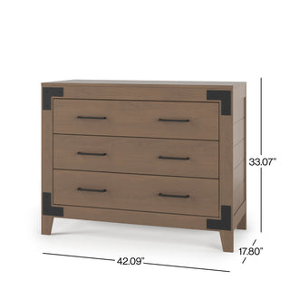 The Child Craft Lucas Dresser in Dusty Heather features three wooden drawers with black metal corner accents and handles. Dimensions: 33.07" H x 42.09" W x 17.80" D.