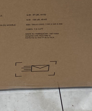 Close-up of a cardboard box displaying shipping details for the Child Craft Surrey Hill 3 Drawer Dresser in Toasted Chestnut. A black envelope icon with motion lines appears in the lower left of the image.