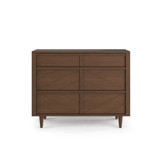 The Child Craft Surrey Hill 3 Drawer Dresser in Toasted Chestnut features a chevron pattern, three drawers, four angled legs, and a modern design with a medium brown wood finish.