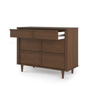 The Child Craft Surrey Hill 3 Drawer Dresser in Toasted Chestnut features angled legs and geometric drawer fronts, with one top drawer partially open to reveal a white box inside.