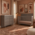 A gray Child Craft Surrey Hill 3 Drawer Dresser, Lunar Gray with a changing pad on top sits next to a matching crib.