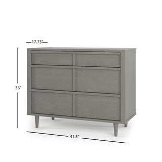 The Child Craft Surrey Hill 3 Drawer Dresser in Lunar Gray features a geometric diamond pattern, angled legs, and three drawers. Dimensions: 33” H x 41.5” W x 17.75” D.