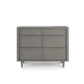 The Child Craft Surrey Hill 3 Drawer Dresser in Lunar Gray features a modern minimalist design with angled legs and three spacious drawers, adding subtle elegance to any nursery.