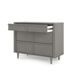 The Child Craft Surrey Hill 3 Drawer Dresser in Lunar Gray features a minimalist, geometric design with tapered legs, three drawers, and a white interior.