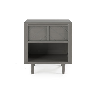 The Child Craft Surrey Hill Nightstand in Lunar Gray features angled legs, a single geometric-pattern drawer, an open lower shelf, and a modern, minimalist design with clean lines and a smooth finish.