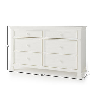The Child Craft Westgate Double Dresser in Vintage Linen features six drawers with round knobs, arranged in two rows. At 34" tall, 56" wide, and 18.5" deep, it’s ideal for nursery storage with a timeless white pine wood look.