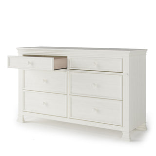 The Child Craft Westgate Double Dresser in Vintage Linen features six drawers, classic molding, and round knobs—making it an ideal nursery dresser.