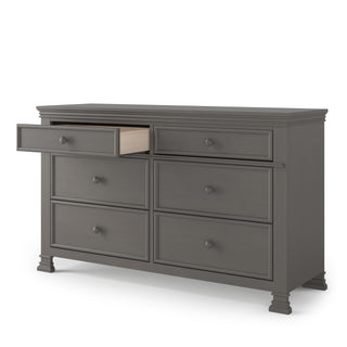 The Child Craft Westgate Double Dresser in Chelsea Gray features six drawers, simple round knobs, and short square feet—an ideal nursery dresser with ample storage.