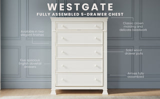 The Child Craft Westgate 5-Drawer Chest in Vintage Linen is shown against a blue paneled wall. This nursery piece features solid pine drawer pulls, crown molding, two finishes, and arrives fully assembled.