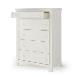 The Child Craft Westgate 5-Drawer Chest in Vintage Linen features round knobs and decorative feet, with one drawer partially open. This classic nursery dresser combines timeless style and practical storage.