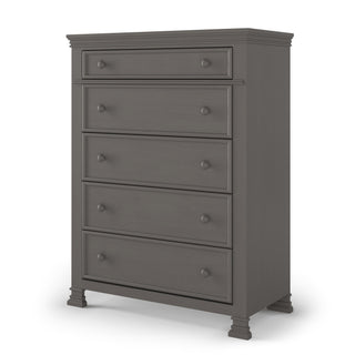 The Child Craft Westgate 5-Drawer Chest in Chelsea Gray features a simple, modern design with five smooth-finish drawers, round knobs, and short decorative legs.