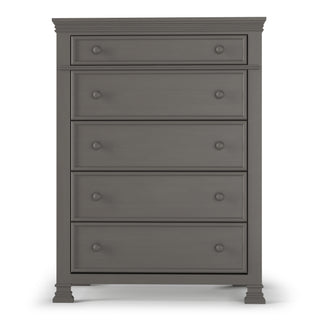 The Child Craft Westgate 5-Drawer Chest in Chelsea Gray features a tall, dark gray wood finish, five drawers with round knobs, classic molding details, and short, square legs.