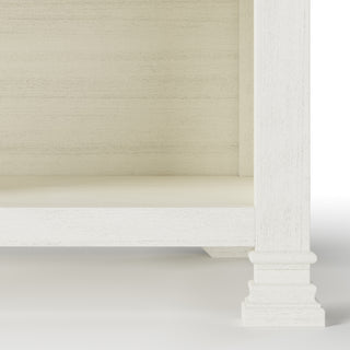 Close-up of the Westgate Nightstand by Child Craft in Vintage Linen, highlighting its decorative square leg and shelf with a light, textured finish—a stylish addition to any nursery furniture collection.