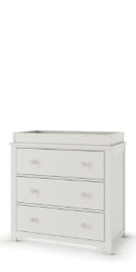 The Child Craft Harmony 3-Drawer Dresser with Changing Table Topper in Brushed Cotton is a white wooden kids dresser with three drawers and raised edges on top—ideal nursery furniture for your little one’s room.