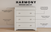 The Child Craft Harmony 3-Drawer Dresser with Changing Table Topper in Brushed Cotton offers smooth-gliding drawers, nickel-tone knobs, sturdy pine wood, and a non-toxic finish—ideal nursery furniture for your little one.