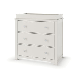 The Child Craft Harmony 3-Drawer Dresser with Changing Table Topper in Brushed Cotton features three drawers with round silver knobs and raised edges, making it ideal for nursery storage or as a changing table.