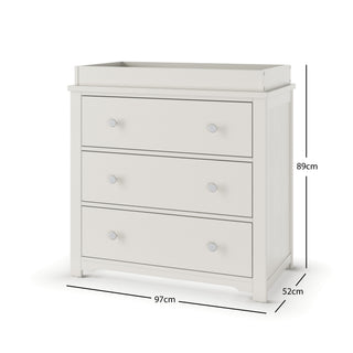 The Child Craft Harmony 3-Drawer Dresser with Changing Table Topper in Brushed Cotton is a white kids dresser with round knobs, measuring 89 cm high, 97 cm wide, and 52 cm deep. It features a raised edge on top for added convenience.