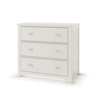 The Child Craft Harmony 3-Drawer Dresser with Changing Table Topper in Brushed Cotton features simple lines and round silver knobs, making it perfect nursery storage, shown on short legs against a plain white background.