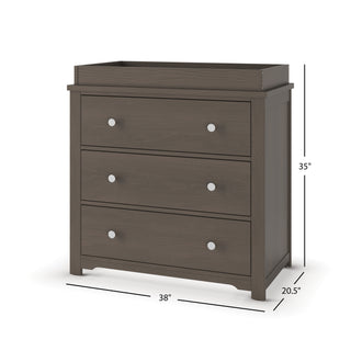 The Child Craft Harmony 3-Drawer Dresser with Changing Table Topper in Dapper Gray features silver knobs, a raised top section, and measures 38"W x 20.5"D x 35"H.