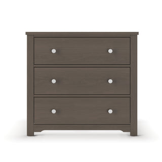 The Child Craft Harmony 3-Drawer Dresser with Changing Table Topper in Dapper Gray features a simple, modern design with three drawers, each with two round silver knobs, and is set against a white background.