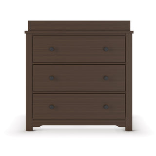 The Child Craft Harmony 3-Drawer Dresser with Changing Table Topper in Brushed Truffle features a simple, modern design with straight edges, three spacious drawers with black knobs, and a flat top perfect for added functionality.