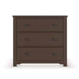 The Child Craft Harmony 3-Drawer Dresser with Changing Table Topper in Brushed Truffle features three spacious drawers with round black knobs, a sturdy build on short legs, and is shown against a white background.
