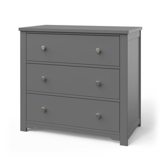 The Child Craft Harmony 3-Drawer Dresser with Changing Table Topper in cool gray features a simple, modern design with silver knobs and short legs—ideal nursery furniture for use as a dresser or changing table.