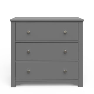 The Child Craft Harmony 3-Drawer Dresser with Changing Table Topper in Cool Gray features simple silver knobs and a modern, minimalistic design, making it ideal nursery furniture. Shown against a white background.