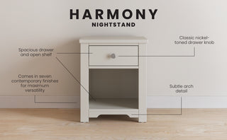 The Child Craft Harmony Nightstand in Brushed Cotton features a spacious drawer with a nickel-toned knob, an open shelf, clean lines, and a subtle arch detail, displayed on a wooden floor with labeled features and “Harmony Nightstand” above.