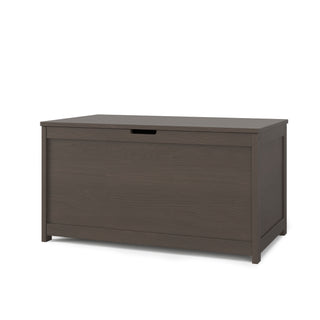 The Child Craft Harmony 33" Kids Toy Box in Dapper Gray is a rectangular dark wood storage chest with a hinged lid and hand slot, shown against a plain white background.
