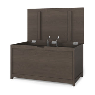 The Child Craft Harmony 33" Kids Toy Box in Dapper Gray features a hinged lid that opens to reveal interior storage space with sturdy metal hinges.
