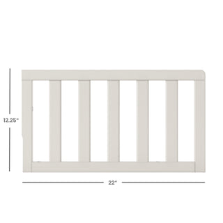 The Child Craft F09501 Toddler Guard Rail in Brushed Cotton features white wood, vertical slats, and measures 12.25" high by 22" wide—perfect for crib conversion. Shown on a white background with labeled measurements.