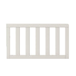 The Child Craft F09501 Toddler Guard Rail in Brushed Cotton is a white wooden bed rail with vertical slats and smooth edges, designed for compatibility with Child Craft cribs and shown against a plain white background.